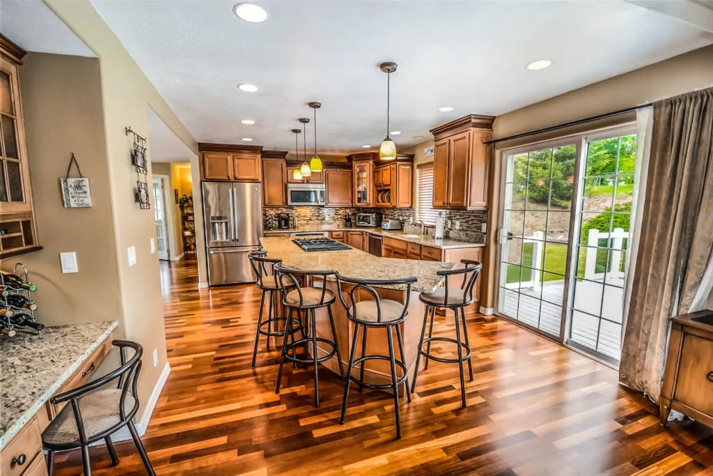 Family kitchen with an island and a polished wooden floor