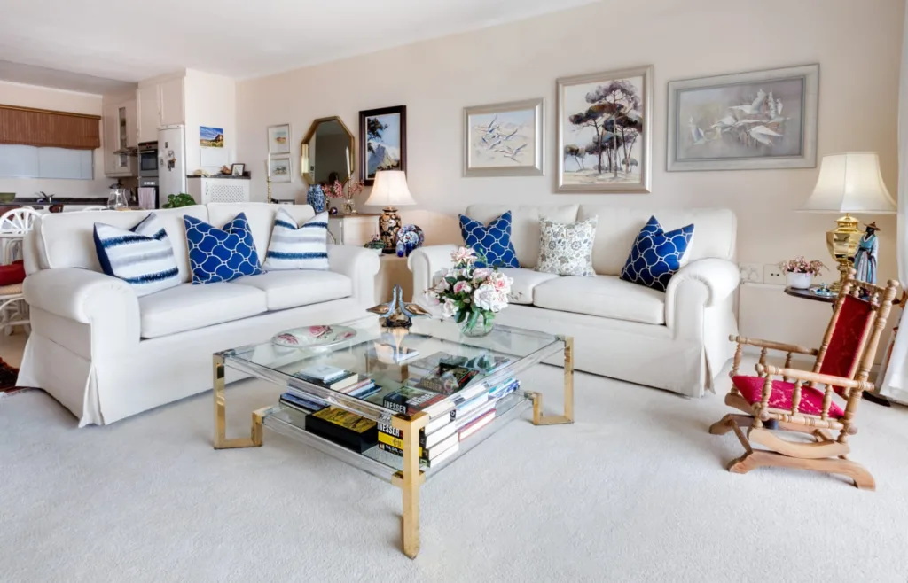 Bright living room with cream sofas and blue cushions